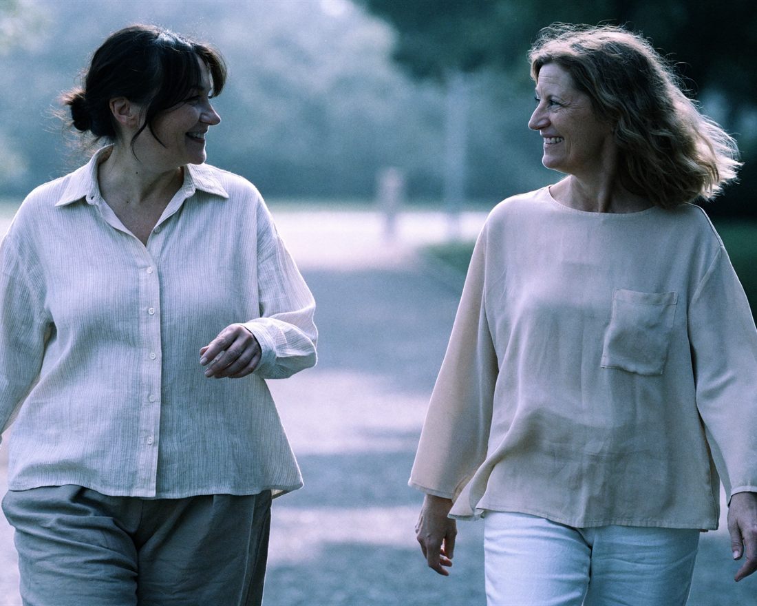 Two women walking together outdoors