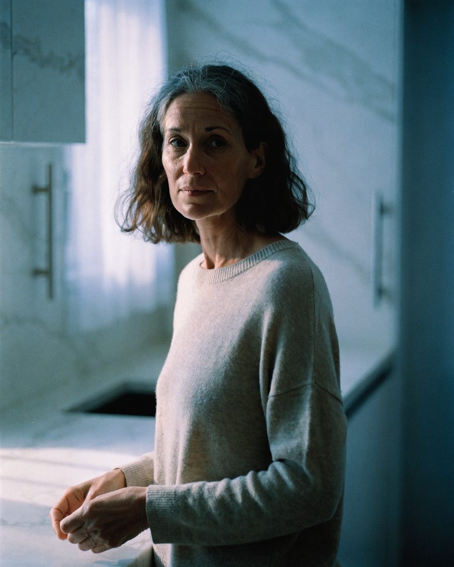A woman in her forties standing in a kitchen